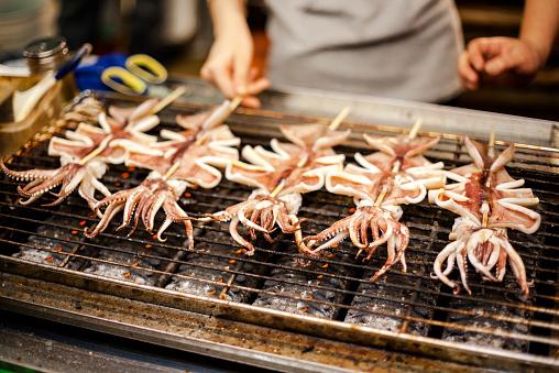 A popular Taiwanese night market food, marinated, grilled squid on a stick.