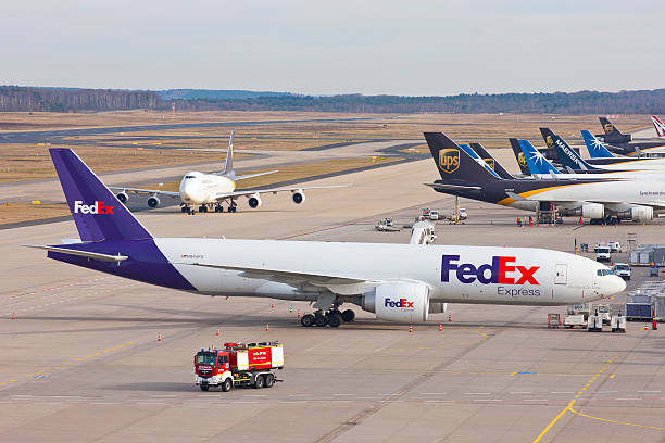 Cologne/Bonn Airport Cologne, Germany - March 08, 2015: Several cargo airplanes at the cargo terminal of the international airport of Cologne/Bonn. In front a FedEx cargo B777. Two UPS Boeing 747 in the background. Airport firefighting in front. bonn photos stock pictures, royalty-free photos & images