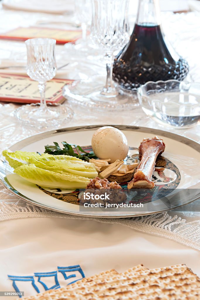 Passover Seder Our Passover Seder table with seder plate, wine, matzoh, haggadah and salt water. Passover Stock Photo