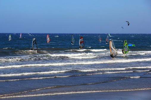 Kite surfers enjoying a sunny October day on the waters in front of the La Cinta, a fine white sand beach in Gallura