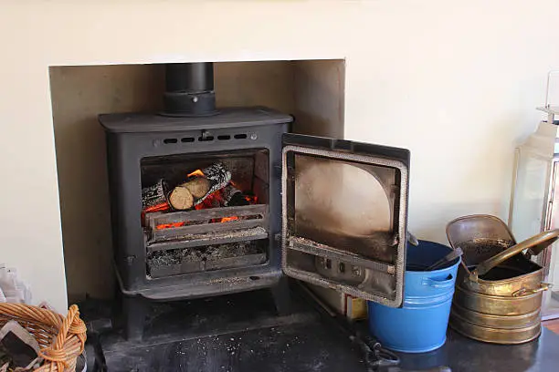 Photo of Image of modern fireplace, woodburning stove, coal buckets, log basket