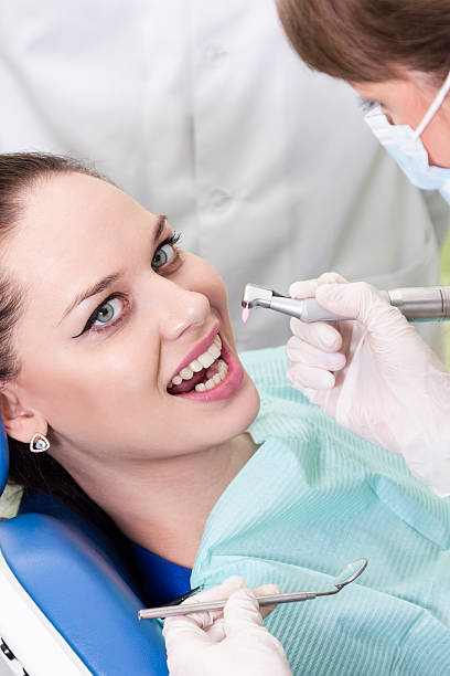 istock Doctor drills patient teeth 539307137