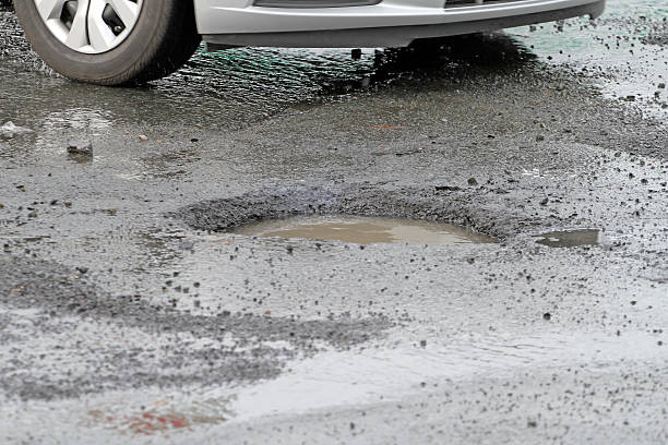 istock Pothole Hazard, Resulting In Vehicle Damage And Insurance Claims 539308297