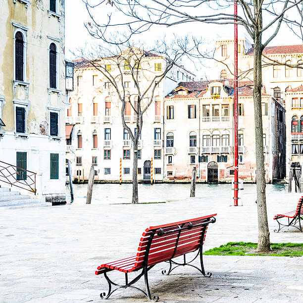 istock Red Bench In Venice Piazza by Canal 539324001