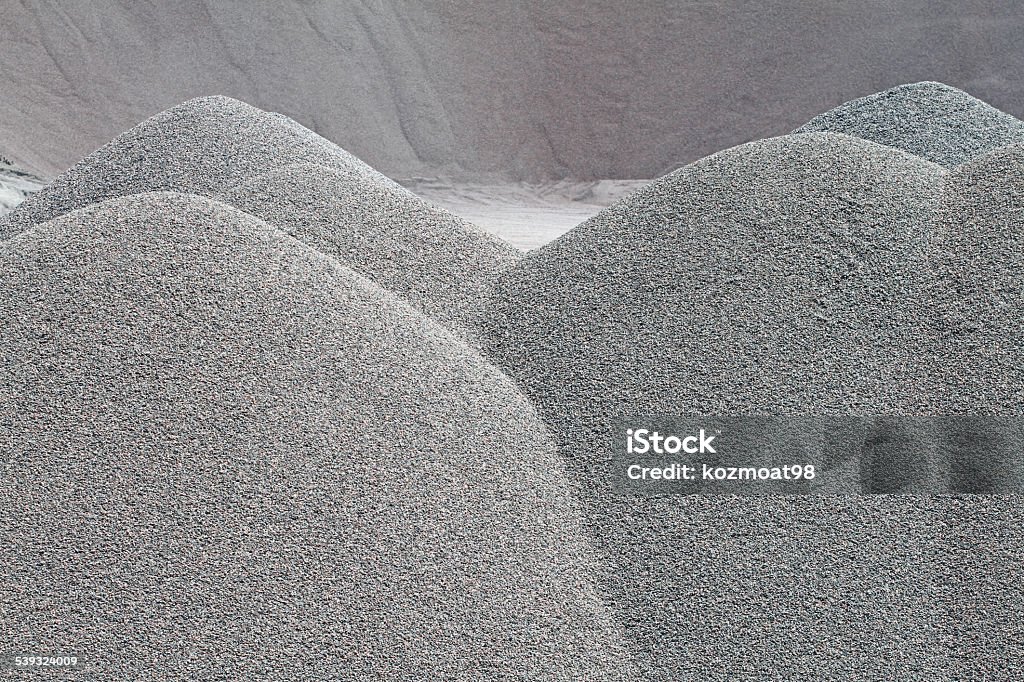 Gravel Quarry, Closeup Gravel piles in a quarry shot in late afternoon sun. Shot with shallow dof to emphasize the mounds of gravel in foreground (in focus) and keeping the background out of focus. 2015 Stock Photo