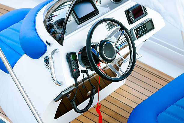 Closeup modern speed boat cockpit control panel with CB radio Elevated view of white and blue modern luxury speedboat rudder control panel, full frame horizontal composition racing boat photos stock pictures, royalty-free photos & images