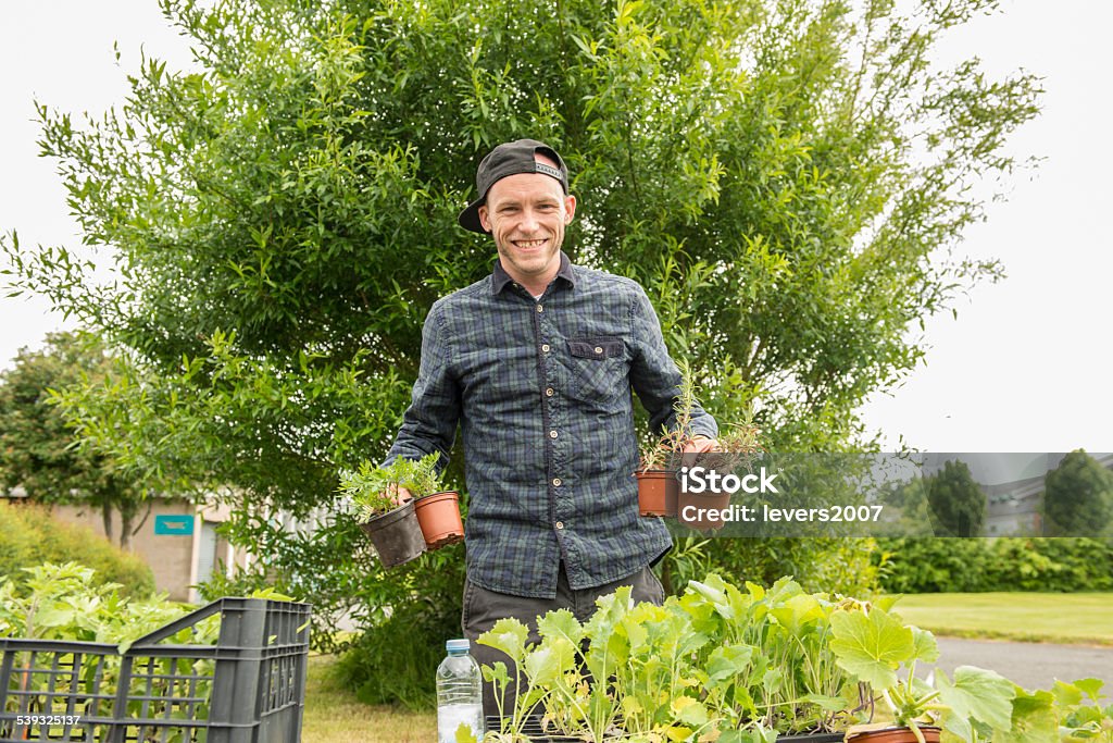 Proud gardener selling plants Proud gardener at his allotment selling plants.  2015 Stock Photo