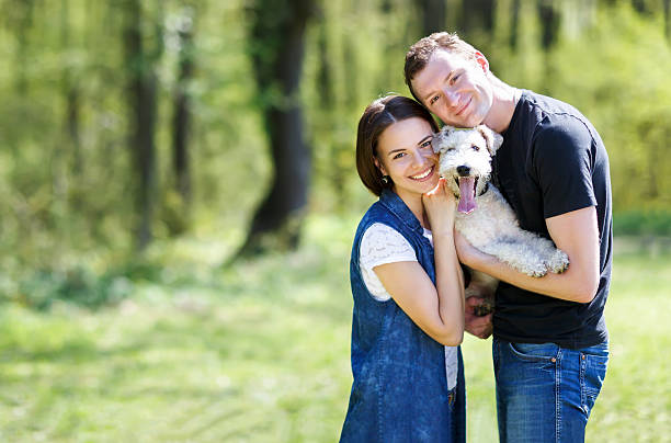 istock Happy young couple and  dog 539325473