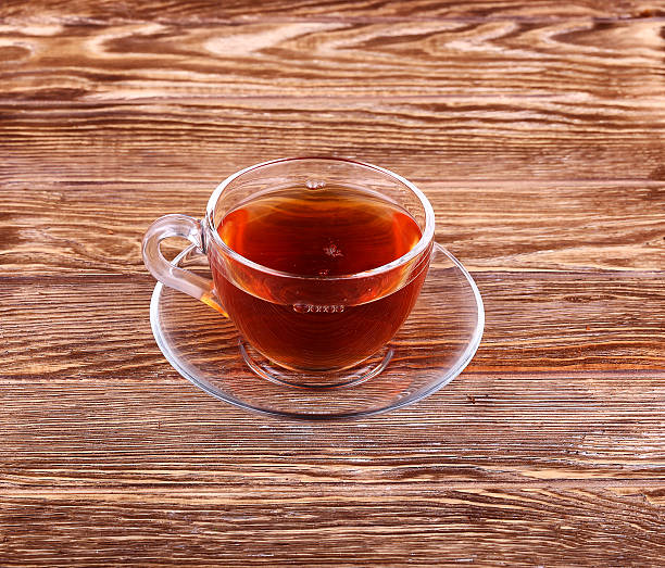 istock Glass cup of tea on a wooden table with 539325481