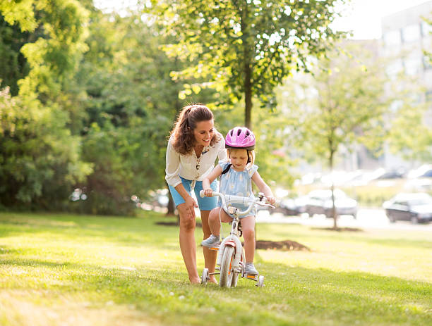 istock Mother teaching her daughter how to ride a bicycle 539325673