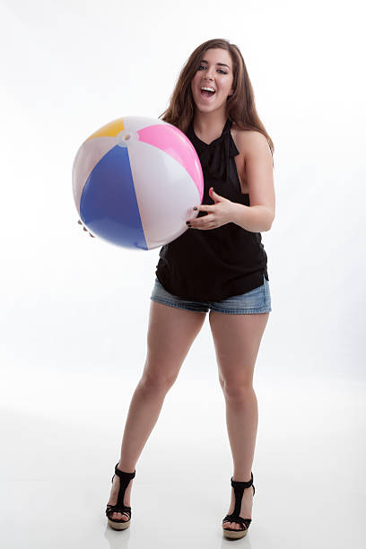 Fun Summer Fashion Model with Beach Ball and a Smile stock photo