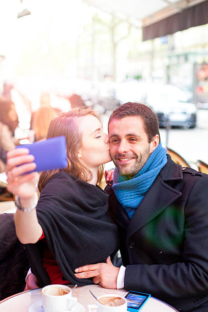 istock Young couple take selfie in a Paris bistro. 539326474