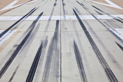 Tire tracks and marks at the end of an airfield