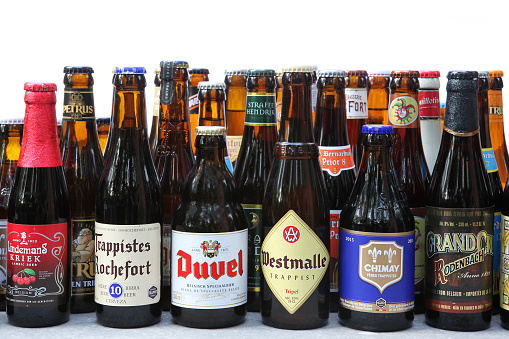 Antwerp, Belgium - June 16, 2015: Variety of Belgian beer bottles against white background. The following beers can be seen in the image: Trappistes Rochefort 10, Lindemans Kriek, Westmalle Tripel, Chimay, Duvel, Rodenbach Grand Cru, and many others. Belgium is famous for its beer with more than a thousand original different beers brewed in Belgium.