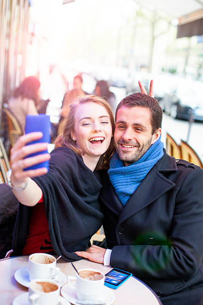 istock Young couple take selfie in a Paris bistro. 539326862