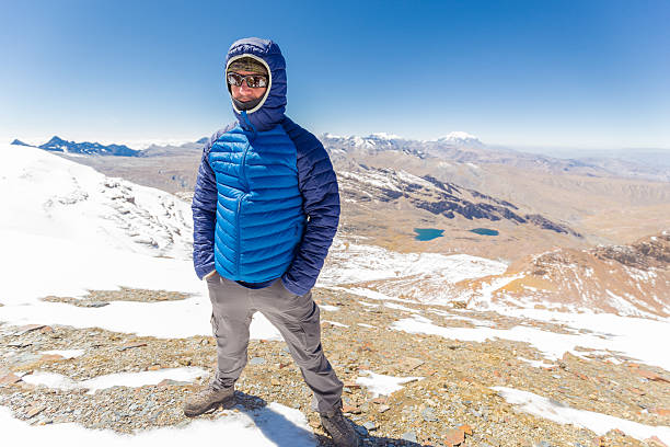 Man guy tourist standing mountain snow summit cold weather, beautiful landscape Cordillera Real range, Bolivia tourism destination.