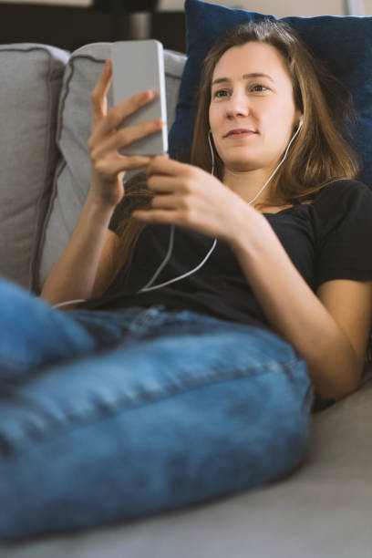 istock Woman lying on the couch, using phone 539327694