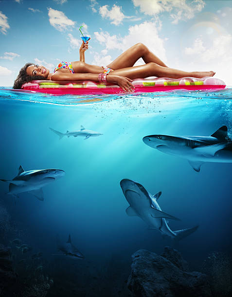 Vacation. Woman is Relaxing. Underwater part Half underwater half over, over-under split shot of the ocean maldivian culture stock pictures, royalty-free photos & images