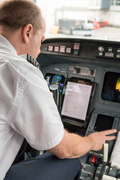 istock Pilot in an aircraft cockpit preparing for the flight. 539328356