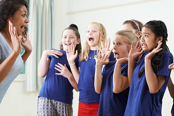 istock Group Of Children With Teacher Enjoying Drama Class Together 539329310