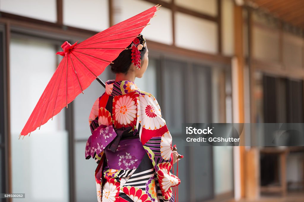 Japanese Girl in Kimono at Hyakumanben Chionji Temple, Kyoto, Japan A young woman in traditional Kimono admiring the magnificent architecture of Hyakumanben Chionji Temple in Kyoto, Japan Japan Stock Photo