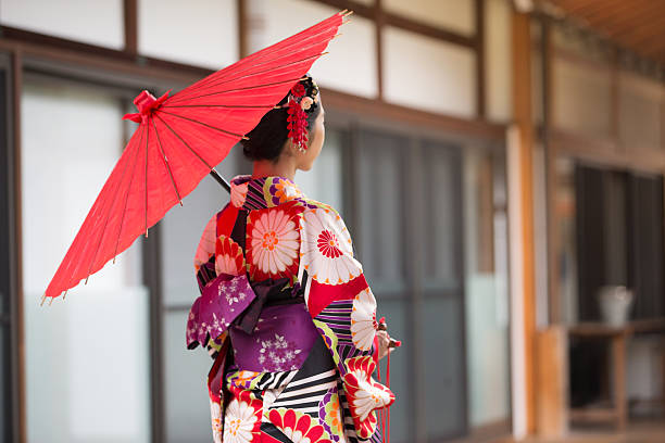 Japanese Girl in Kimono at Hyakumanben Chionji Temple, Kyoto, Japan A young woman in traditional Kimono admiring the magnificent architecture of Hyakumanben Chionji Temple in Kyoto, Japan kimono photos stock pictures, royalty-free photos & images