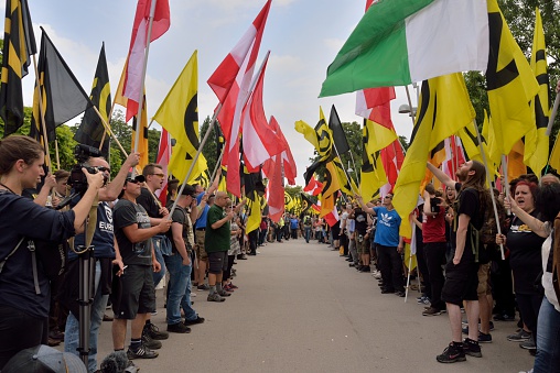 Vienna, Austria - June 11, 2016: Demonstrators of the austrian identitarian movement form a guard of honor of flags in Vienna.