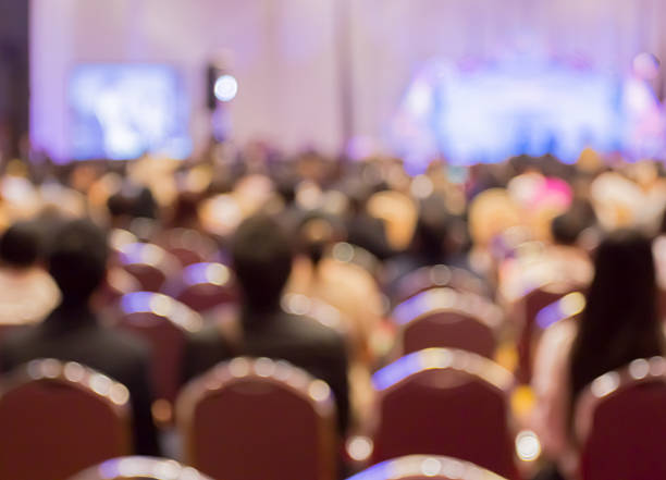 istock Blur  row of  people sitting  in auditorium with screen 539330974
