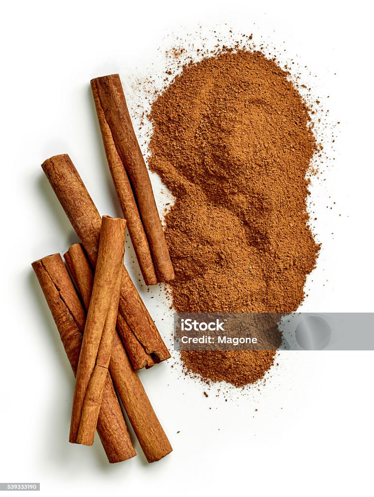 heap of ground cinnamon heap of ground cinnamon isolated on white background, top view Cinnamon Stock Photo