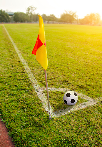 Corner flag with ball on a soccer field