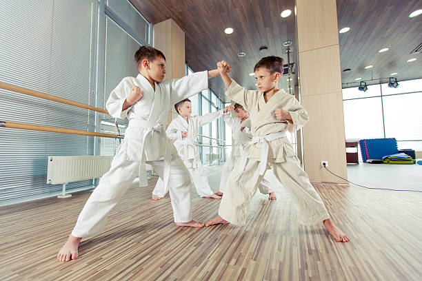 istock young, beautiful, successful multi ethical kids in karate position 539336474