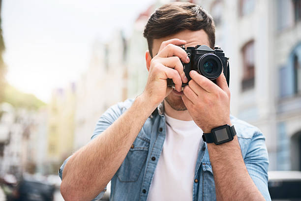 istock Pleasant cheerful man holding photo camera 539336862