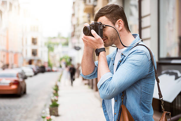 istock Cheerful delighted man taking photos 539338010