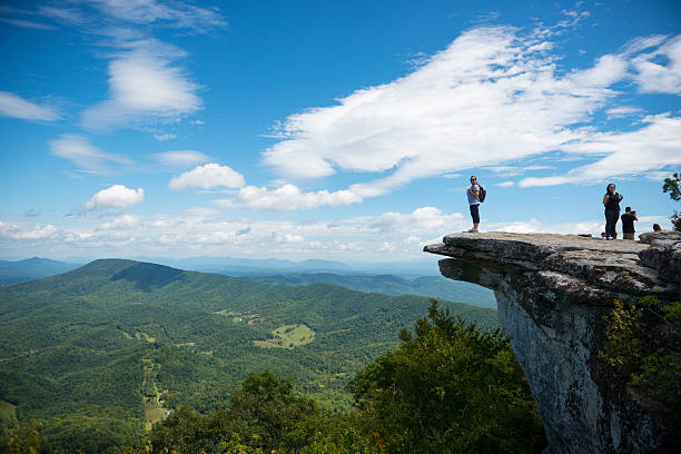 Catawba, Virginia, USA - September 1, 2014: Hikers enjoy the view of the Appalachian Mountains from McAfee Knob on Catawba Mountain, near Roanoke, Virginia. It is one of the most popular overlooks on the Appalachian Trail and is situated at an elevation is 3,171 feet.