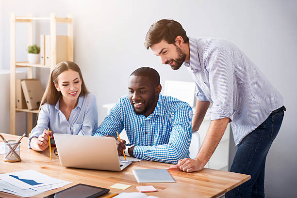 istock Positive smiling colleagues working on the project 539340642