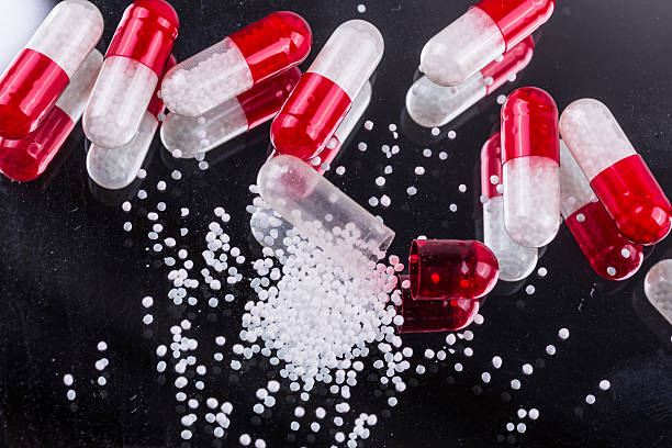 istock red-white capsules of them on a mirrored background 539342350