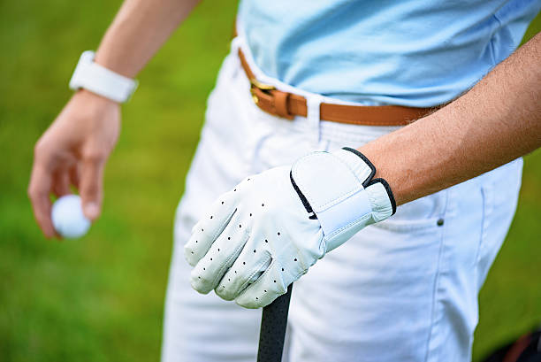 istock Golfer holding ball and golf club 539343808