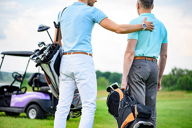 istock Two partners of game standing on golf course 539343980