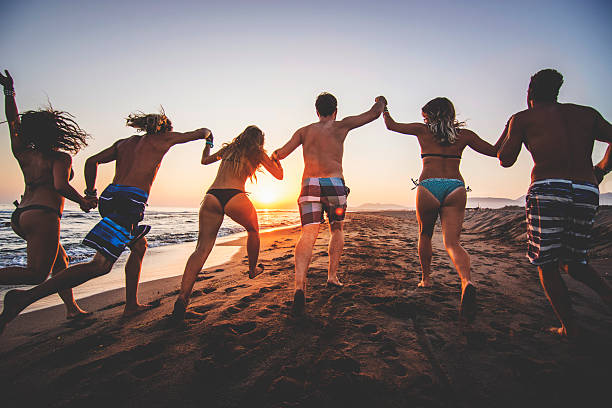 istock Group of friends running at the beach 539344711