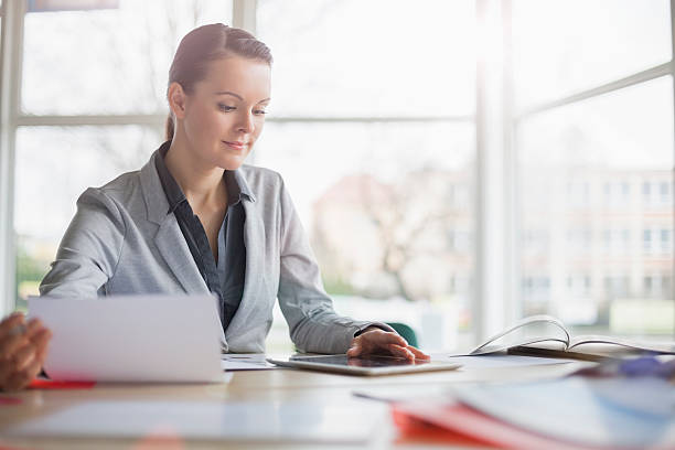 istock Confident young businesswoman at office desk 539345202