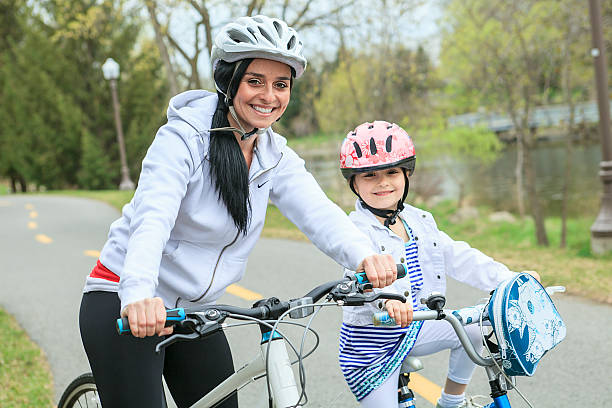 istock Beautiful and happy young on bicycle with her daughter. 539345279