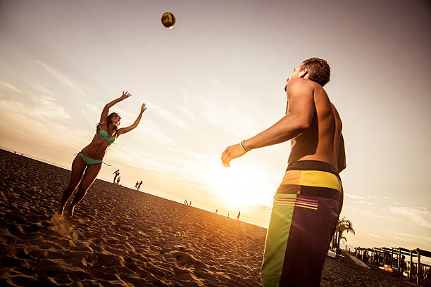 istock Couple playing volleyball at the beach 539345699