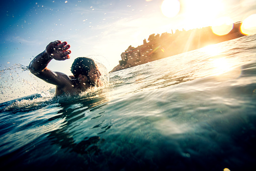 Young man swimming near St. Stefan, Montenegro