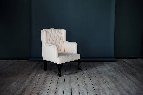 istock One classic armchair against a dark blue wall and floor 539345721