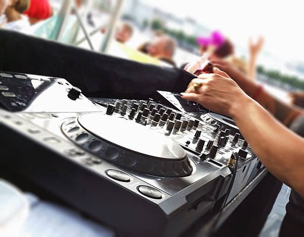 istock Female Dj mixes dance tracks at open air party 539346493