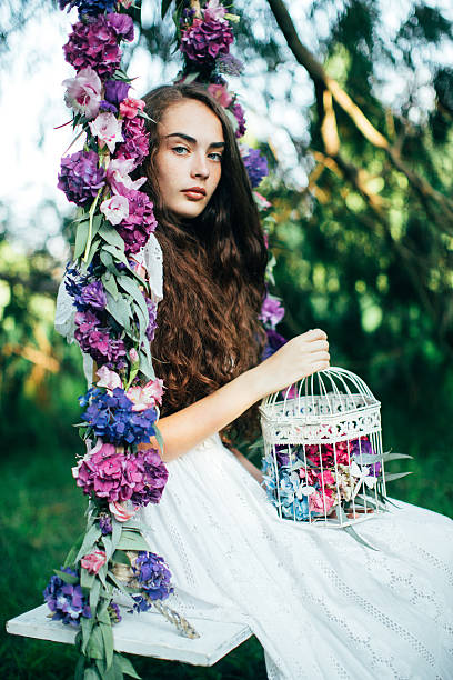 istock Beautiful young girl on a swing 539346691