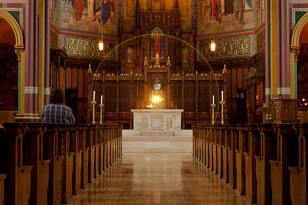Salt Lake City, Utah, USA - 12 October 2005:  Hispanic man sits in a pew and prays inside the Cathedral of the Madeline.