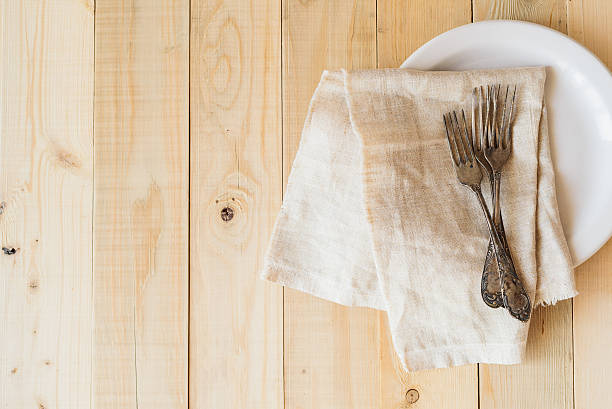 istock Top view three antique forks and napkin on white plate 539351800