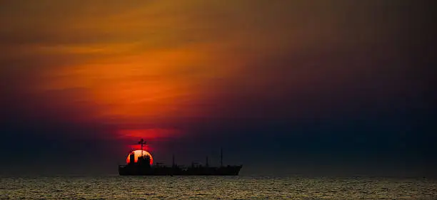 The big sun with ship at sunset, Rayong, Thailand