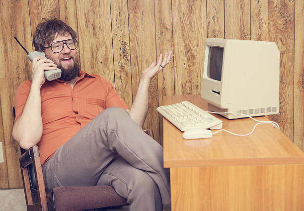 istock retro cell phone 1980s man at computer 539354462
